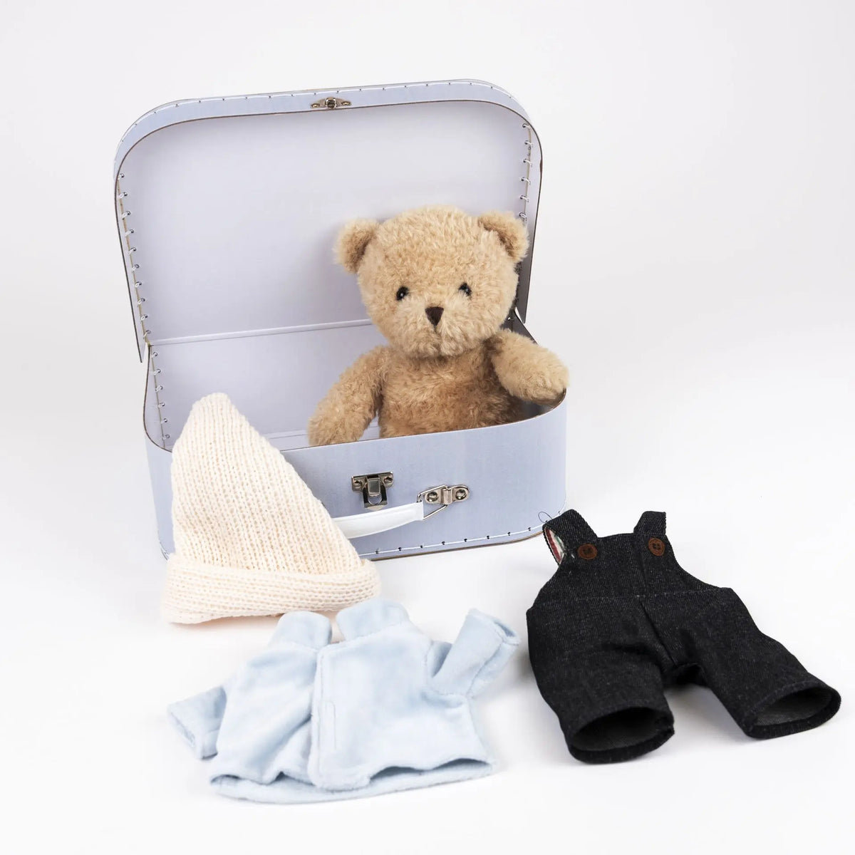 Morris bear with clothes in a case