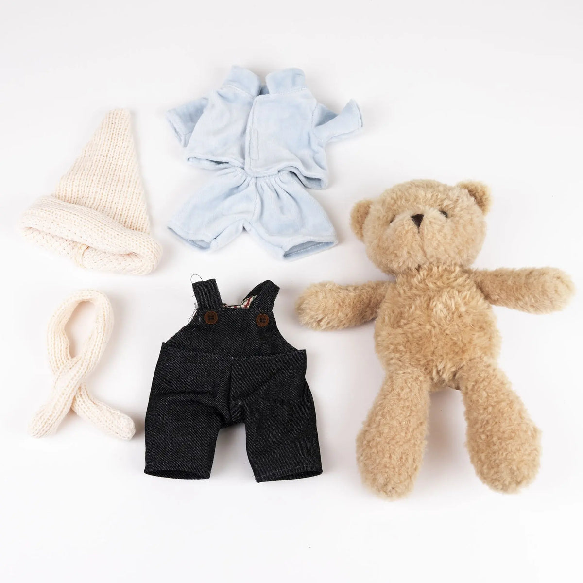 Morris bear with clothes in a case