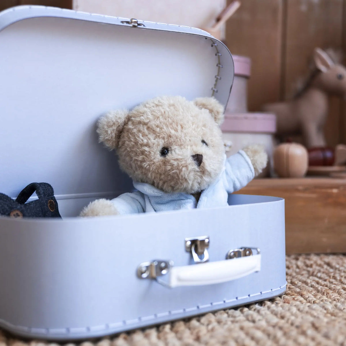 Morris bear with clothes in a case